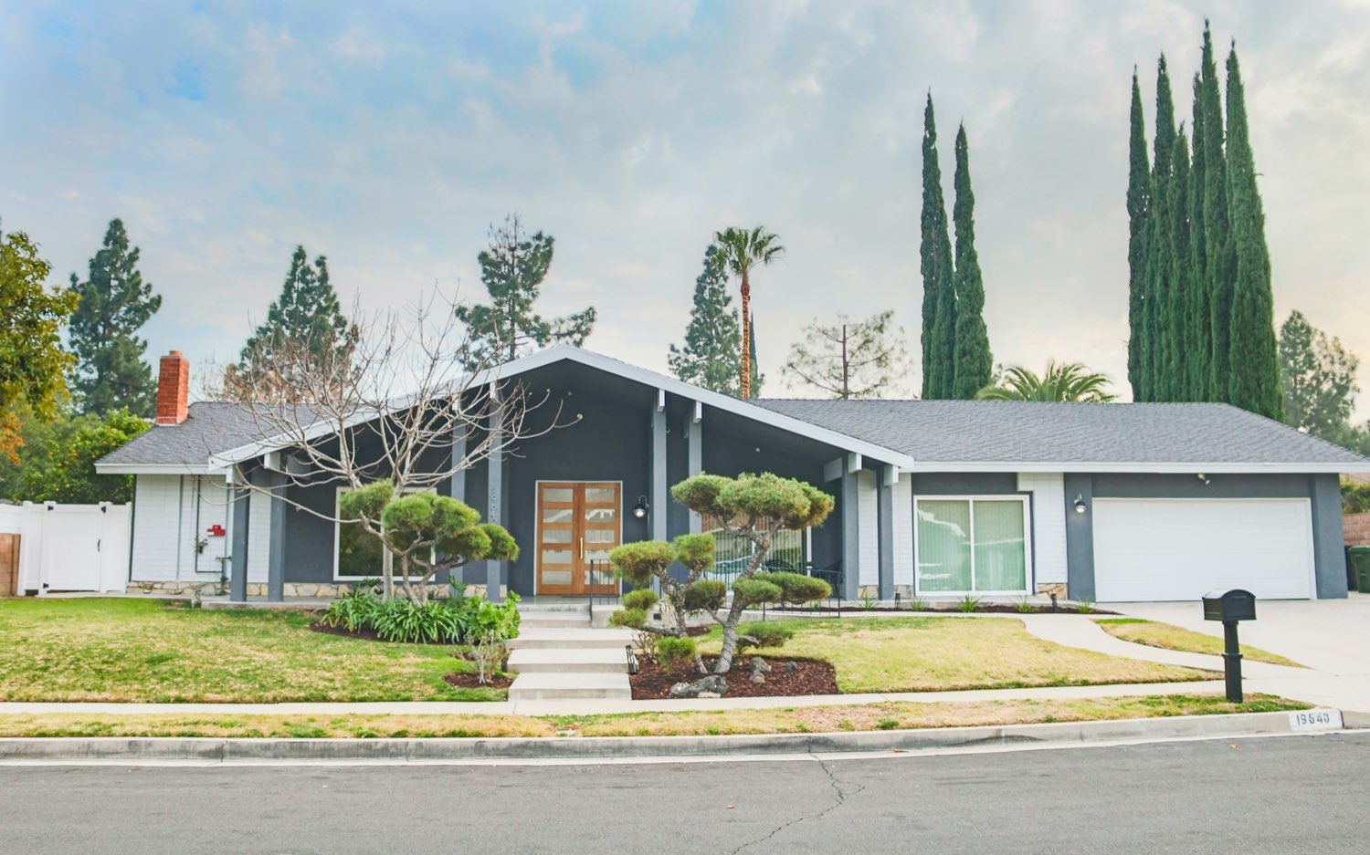 Front exterior of a New Start CLHF residential care home with mid-century architecture and a landscaped yard