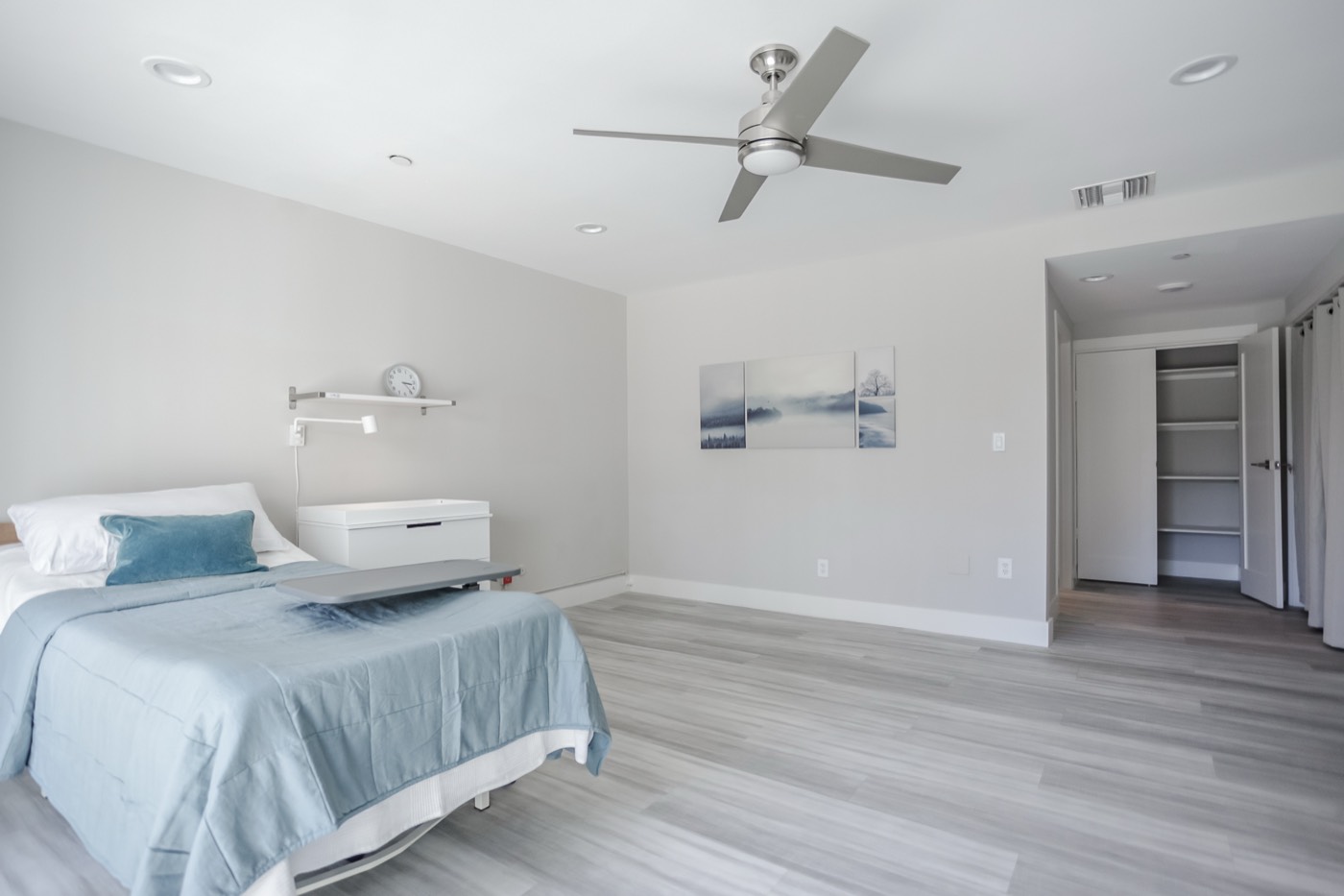 Private care bedroom with hospital bed and overbed table at a New Start CLHF